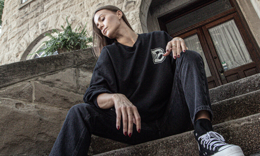 Woman sitting on the stoop of a brownstone