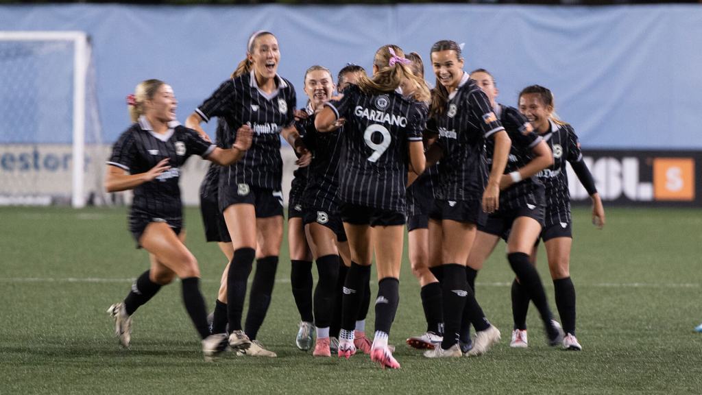 The Brooklyn FC team celebrates a goal by Jess Garziano