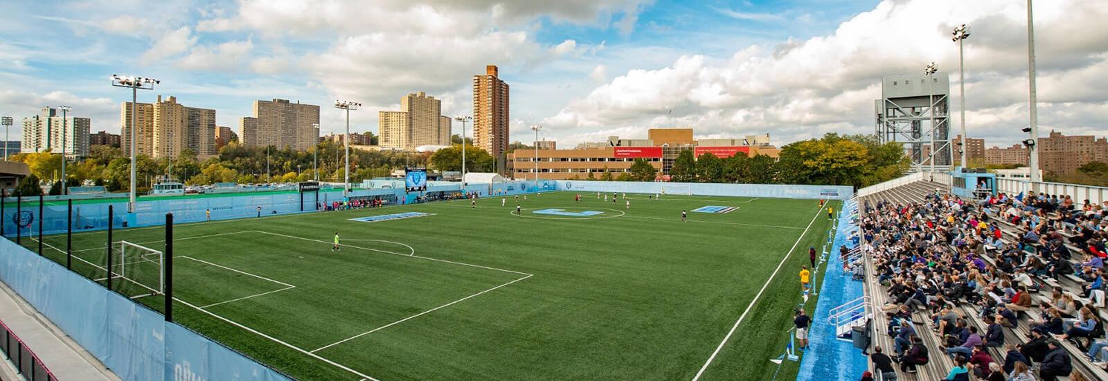 Columbia University's soccer field, with the skyline of northern Manhattan in the background