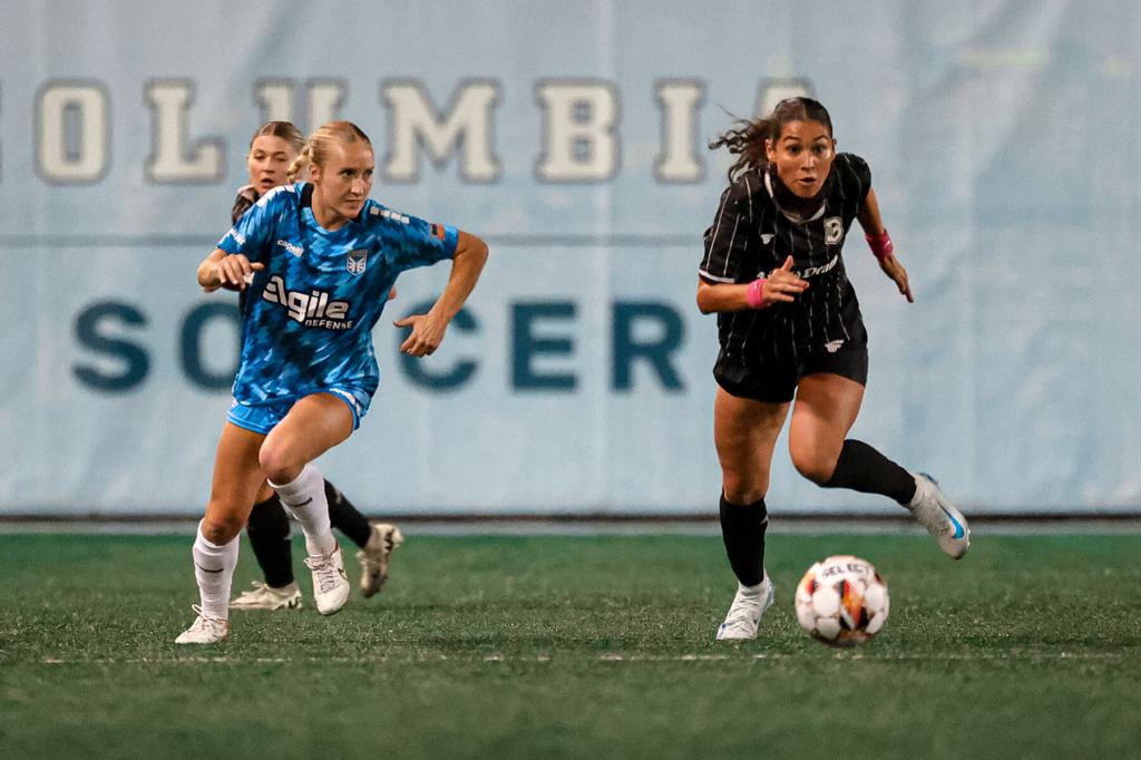 Brooklyn Women's Football player races an opponent for a loose ball