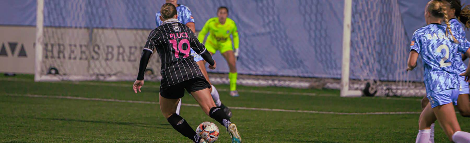 Mackenzie Pluck races with the ball towards the opponent's goal